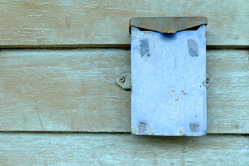Old Metal Box on Wood Wall Background.
