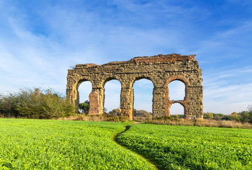 Fototapeta na wymiar Rome, Italy. A picturesque landscape with the ruins of an ancient Roman aqueduct.