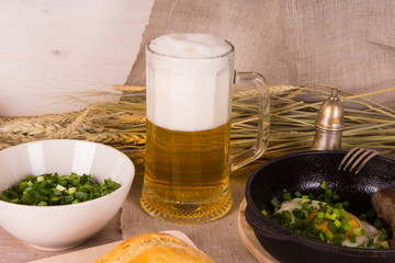 Beer with scrambled eggs and fried sausage