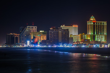 The skyline and Atlantic Ocean at night, in Atlantic City, New Jersey. © jonbilous