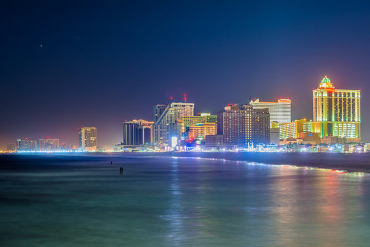 The skyline and Atlantic Ocean at night, in Atlantic City, New Jersey.