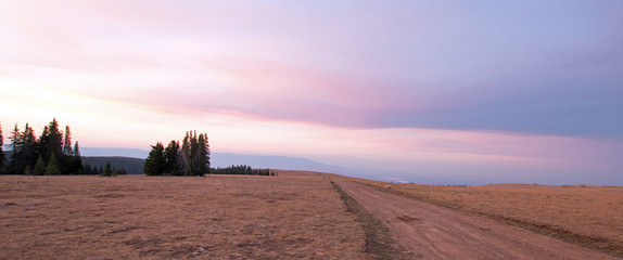 Country gravel road on Sykes Ridge at Sunrise in the Pryor Mountains Wild Horse Range on the Montana Wyoming state line USA