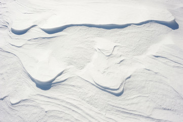 Coarse texture of the snow, accented by a sliding sun light