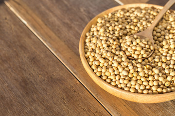 Soybean in bowl on wooden table background
