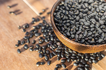 Black bean in bowl on wooden table background