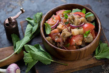 Salad with baked aubergines, fresh tomatoes and mint leaves, horizontal shot