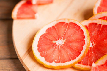 Photography of a grapefruit slice on a wooden cutting board