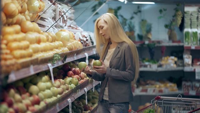 Beautiful young woman shopping in a grocery store or supermarket