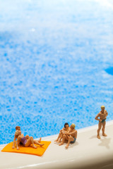 Fototapeta na wymiar Miniature people: Vacationers are enjoying the beach