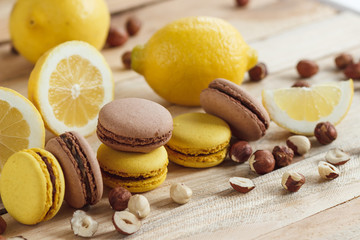 Yellow and brown french macarons with lemon and hazelnuts