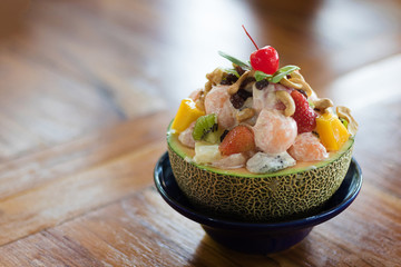  healthy fresh Delicious fruits salad in plate on table close-up and copy space