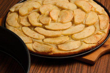 Apple pie near baking tray on table
