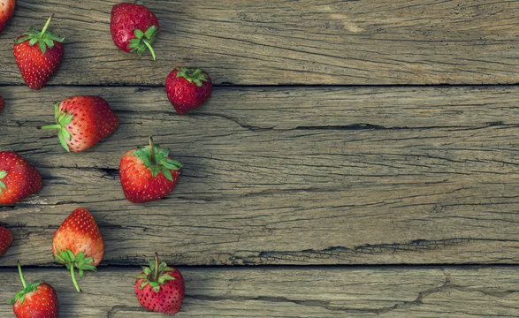 strawberries on the old wooden table background.