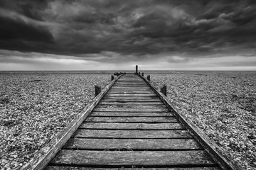 Concept image of path to nowhere in desolate beach black and white landscape