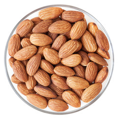 Almonds in glass bowl isolated on white background