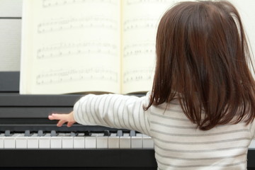 Japanese girl playing a piano (2 years old)