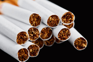 cigarette close up isolated on blak background. Drug addiction. Tobacco smoking. cancer. Nicotine....