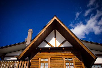 The roof top of traditional wooden house with chimney.