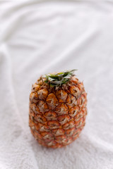 whole pineapple on white fabric
