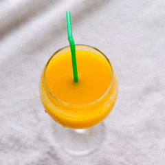 Pineapple, orange juice in a glass with a straw, juice for healthy nutrition