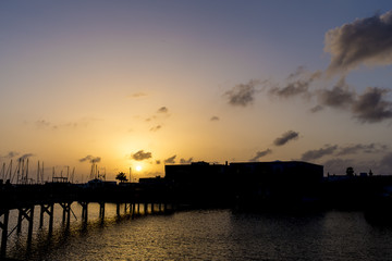 Dark sunset colourful sky on a harbour pier bridge