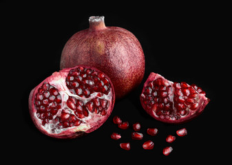 Juicy pomegranate and its half. Ripe pomegranate fruit isolated on white background. Fruit. Healthy food. Vitamins.