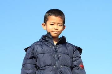 Japanese boy under the blue sky (first grade at elementary school) (winter cloth)