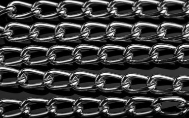 Chain heap - abstract metal background. Collection silver jewelry chains on an isolated black...