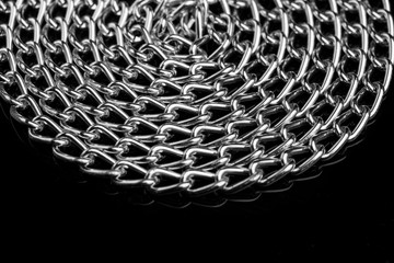Chain heap - abstract metal background. Collection silver jewelry chains on an isolated black...
