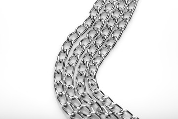 Chain heap - abstract metal background. Collection silver jewelry chains on an isolated black background. Set of different lenght metal chain. Accessories. Bijouterie. Silver.