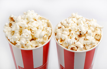 Popcorn in red and white cardboard box. Popcorn border isolated on white. Film. Fast food. Corn