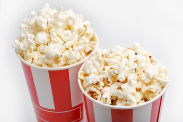 Popcorn in red and white cardboard box. Popcorn border isolated on white. Film. Fast food. Corn