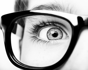 Portrait of a boy wearing eyeglasses blue eyes close, macro studio shot