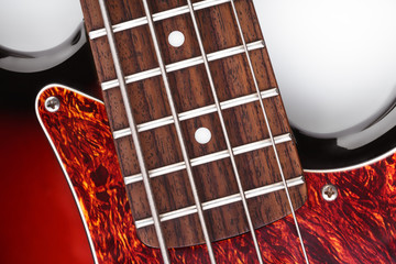 Metallic volume treble guitar bass knobs. Electric guitar. Red electric bass guitar close-up....