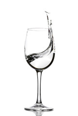 A splash of crystal clear water in a glass for wine. Water splashes. Drinking water. Alcohol.