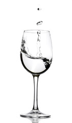 A splash of crystal clear water in a glass for wine. Water splashes. Drinking water. Alcohol.