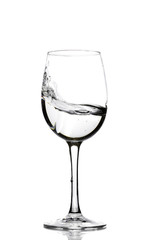A splash of crystal clear water in a glass for wine. Water splashes. Drinking water. Alcohol.