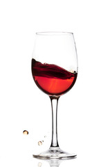 Classic Glass of Red Wine isolated on a white background. Splashing red wine in a glass. A splash of red wine in a glass. Grapes. Alcohol.