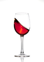 Classic Glass of Red Wine isolated on a white background. Splashing red wine in a glass. A splash of red wine in a glass. Grapes. Alcohol.