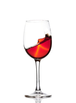 Classic Glass of Red Wine isolated on a white background. Splashing red wine in a glass. A splash of red wine in a glass. Grapes. Alcohol.