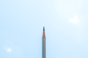 pencil on blue sky background