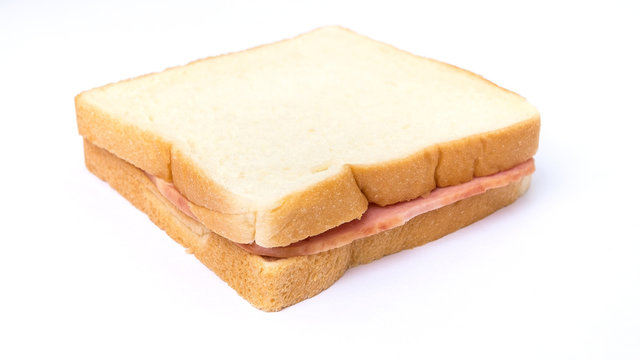 sliced white bread with ham sandwich on white background