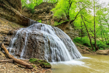 Beautiful scenery of Rufabgo river waterfall callaed Heart of Love in green Caucasus mountain forest at spring
