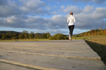 girl running on the wooden pavement
