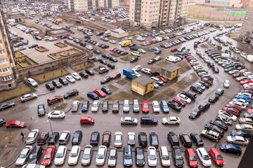 Parked cars in the courtyard of a block of flats in a new district of St. Petersburg