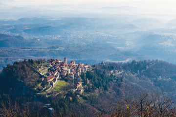 Fototapeta na wymiar Sacro Monte of Varese, Varese, Italy. Aerial view. The village also called Santa Maria del Monte, in 2003 entered from UNESCO in list of World Heritage. To right, the sacred way with six chapels