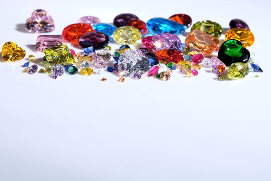 Colorful of different gemstones with space for text on white background.