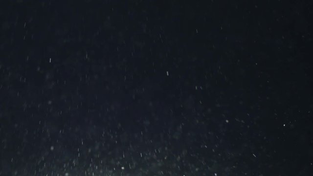 Slow motion of blue dust particles with ligh tleak fly in the air, 180fps prores footage