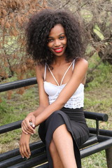 Fototapeta na wymiar Relaxed outdoor portrait of beautiful, young African lady