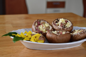 Champignons stuffed with a mixture of cheese and salami.